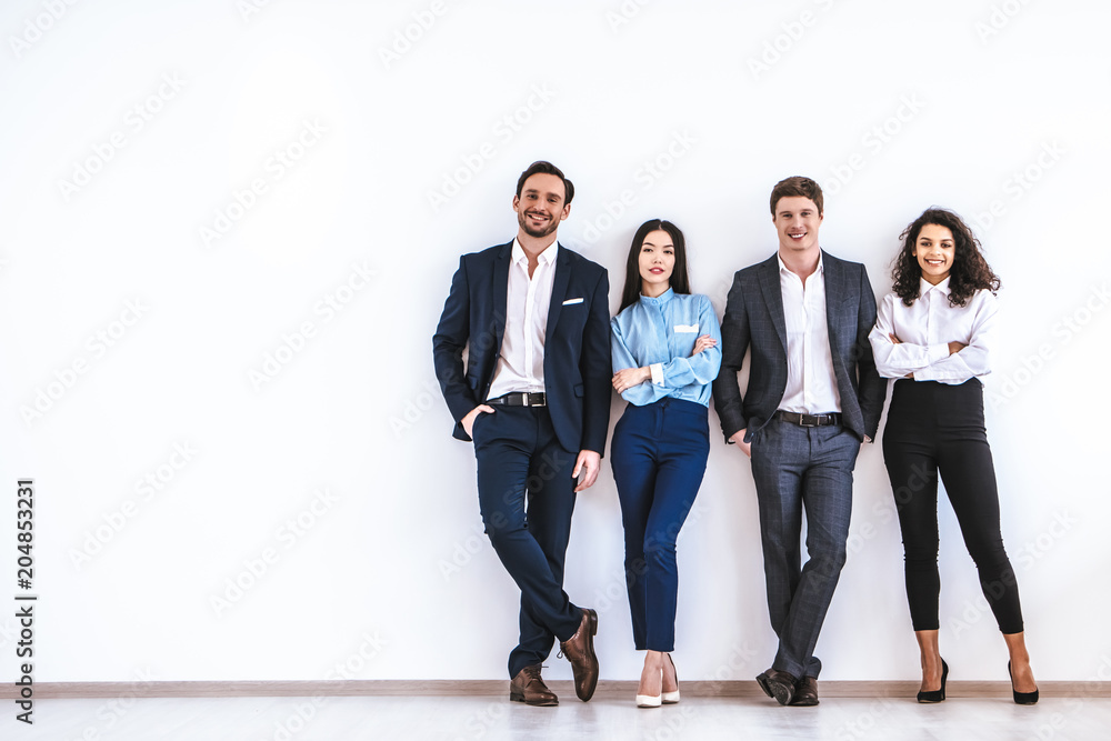 The business people standing on the white wall background - obrazy, fototapety, plakaty 