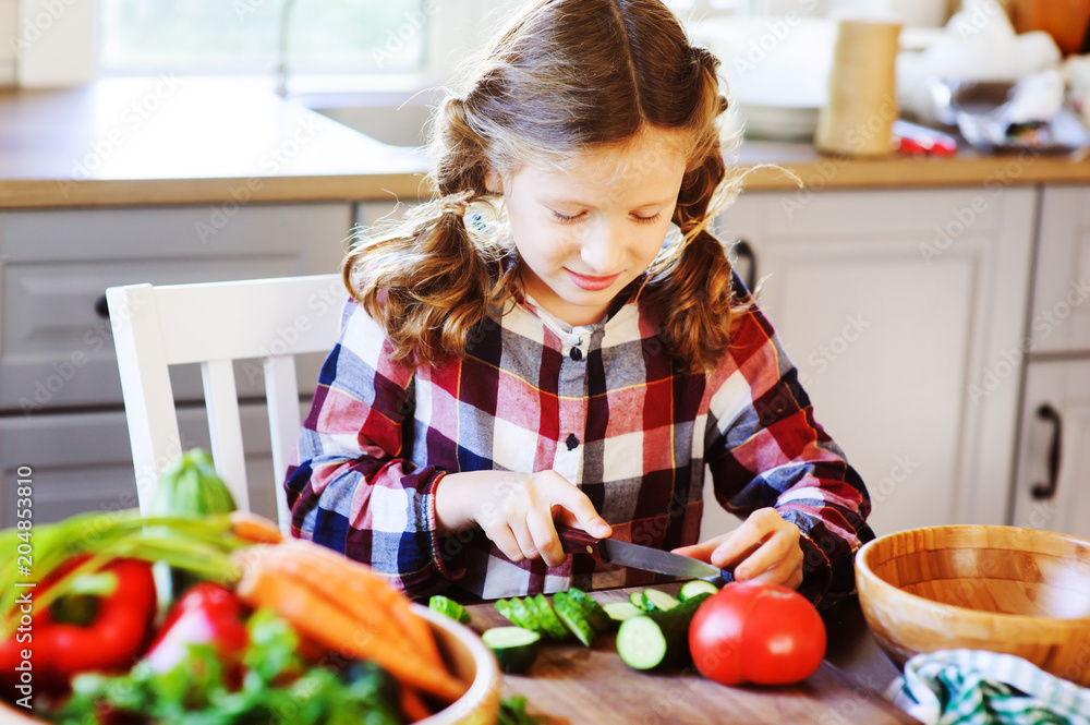 8 years old child girl help mom to cook vegetable salad at home. Healthy eating, little helper concept 8 years old child girl help mom to cook vegetable salad at home. Healthy eating, little helper concept
