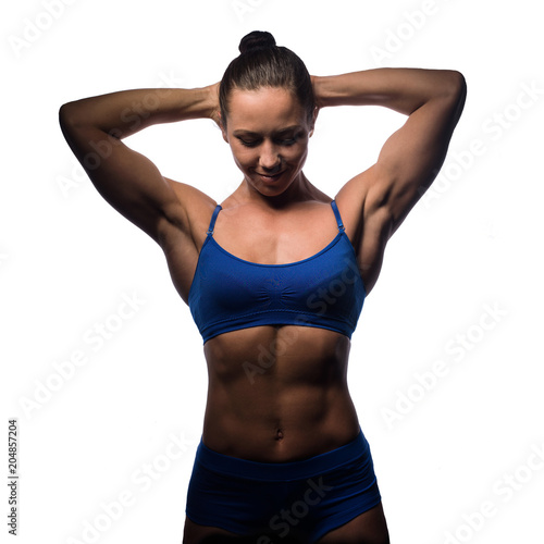 Female bodybuilder in sportswear with accessories, on a light background.Studio.