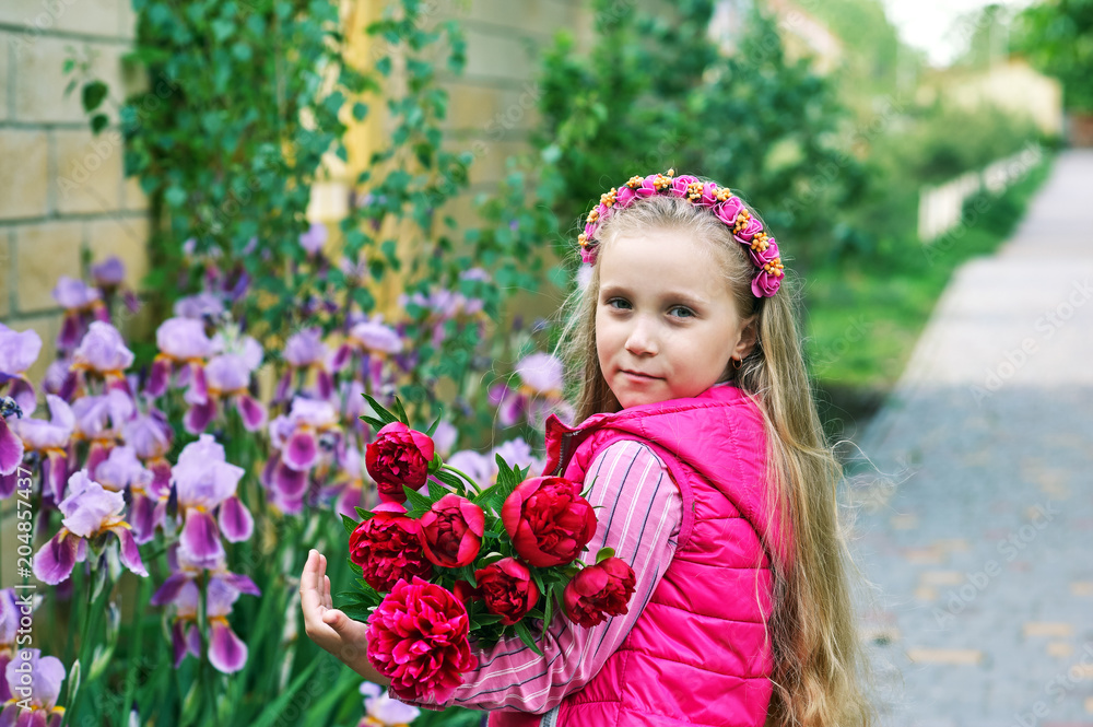 Portrait of a lovely little girl with a bouquet of peonies Portrait of a lovely little girl with a bouquet of peonies