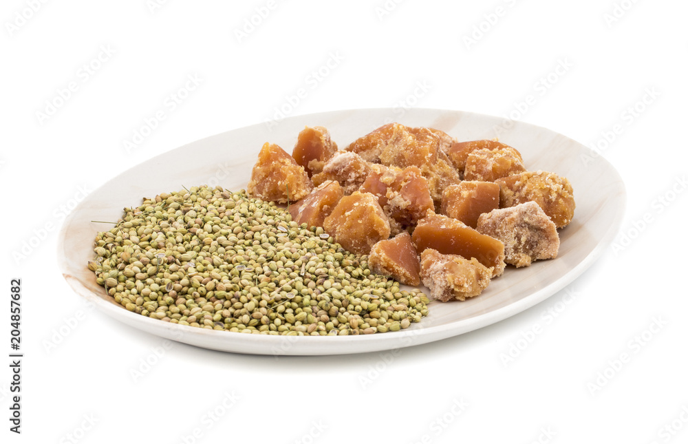Group of jaggery with Coriander Seeds also Know as Gur, Goor or Gud isolated on White Background Group of jaggery with Coriander Seeds also Know as Gur, Goor or Gud isolated on White Background
