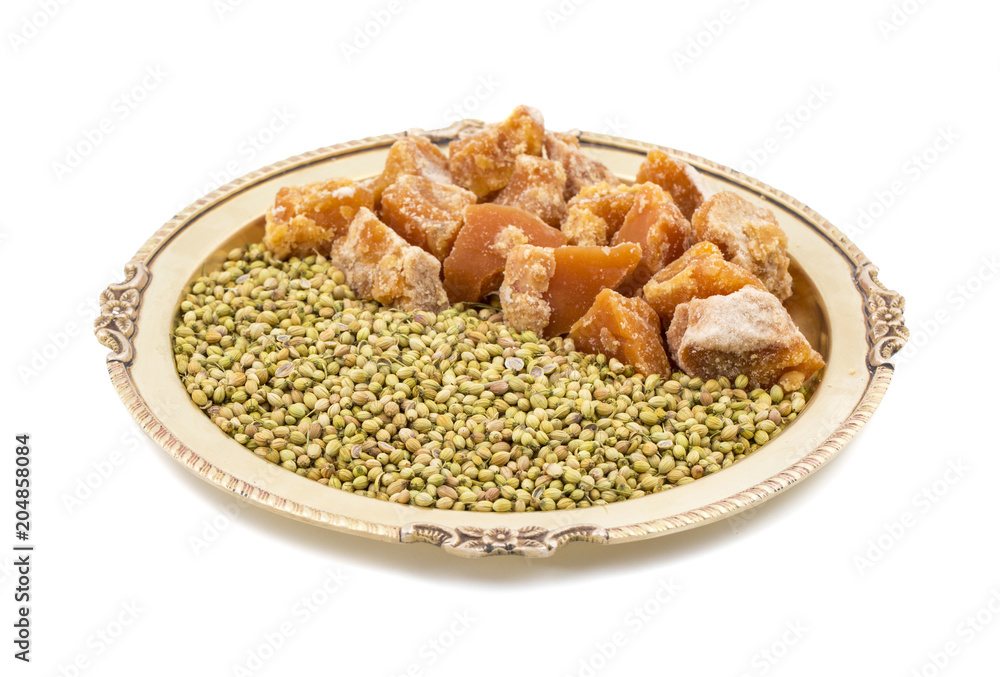 Group of jaggery with Coriander Seeds also Know as Gur, Goor or Gud isolated on White Background Group of jaggery with Coriander Seeds also Know as Gur, Goor or Gud isolated on White Background