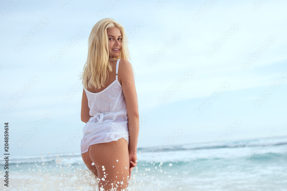 Attractive girl on the beach in summer