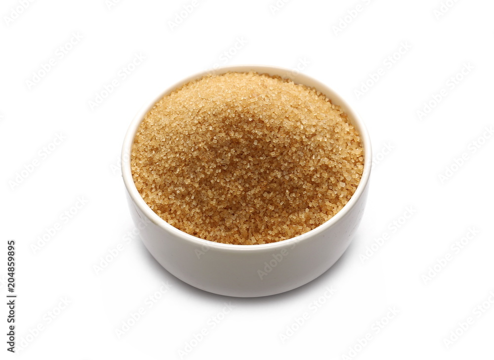Brown cane sugar in porcelain bowl isolated on white background, sugarcane texture Brown cane sugar in porcelain bowl isolated on white background, sugarcane texture