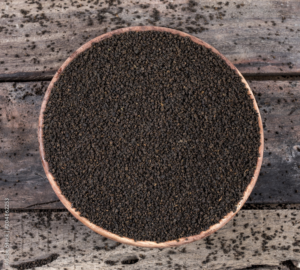 Aromatic Black Tea Loose or Dried Tea Leaves on Wooden Table