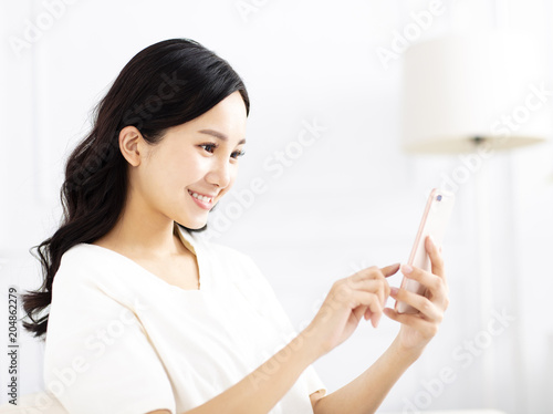 beautiful young woman watching the mobile phone
