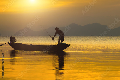 silhouette the fisherman and fishing boat © noppharat