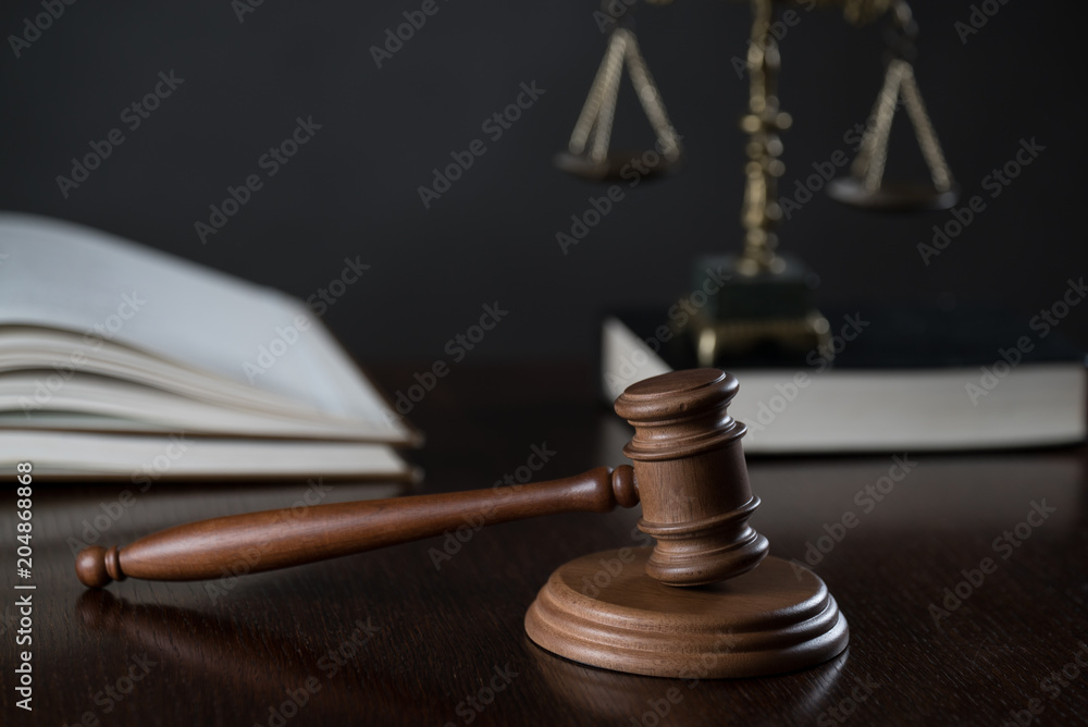 Law theme, mallet of the judge, wooden desk, books Law theme, mallet of the judge, wooden desk, books