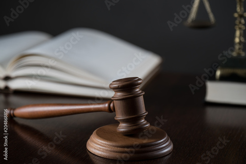 Law theme, mallet of the judge, wooden desk, books