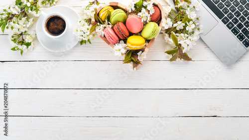 Macaroons and a fragrant cup of coffee. Top view. On a wooden background. Copy space.