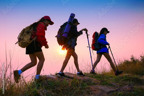 Young asian people hiking in the forest during summer at sunset,travel,tourism and teamwork concept