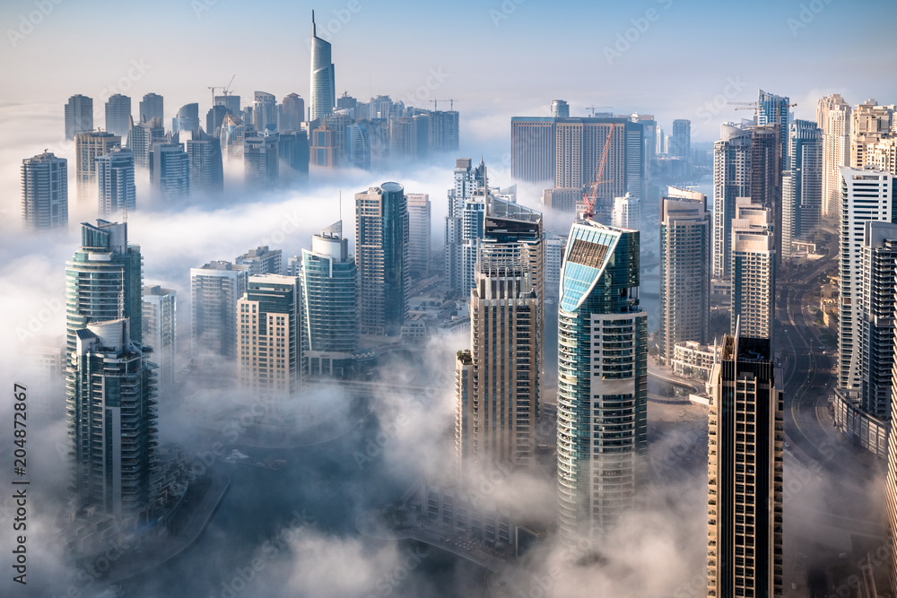 Dubai skyline, an impressive aerial top view of the city in Dubai Marina on a foggy day - obrazy, fototapety, plakaty 