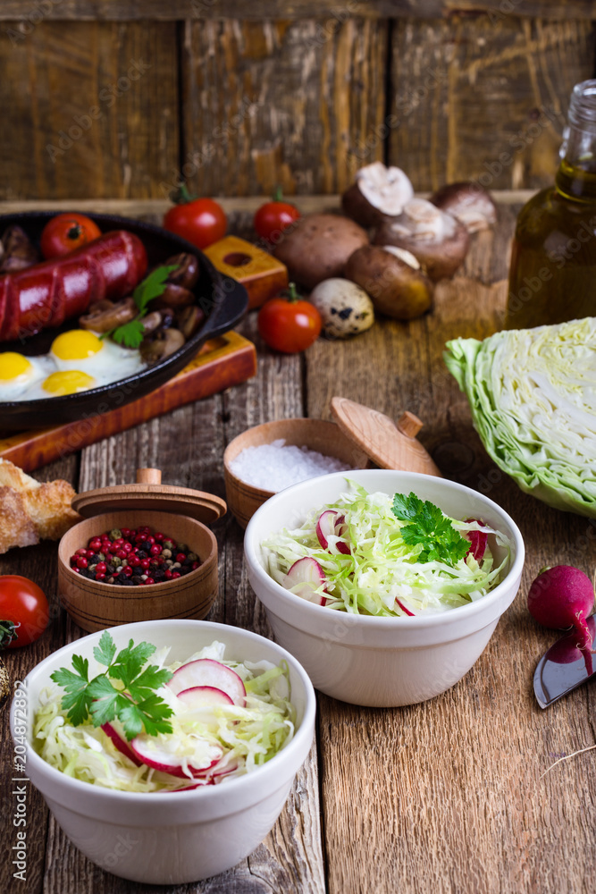 Bowls of fresh vegetable salad with cabbage and radish Bowls of fresh vegetable salad with cabbage and radish