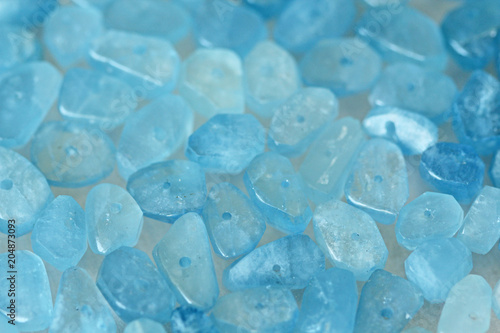 Aquamarine is blue. Natural stone is blue aquamarine. The background is aquamarine. Place for text. Card photo