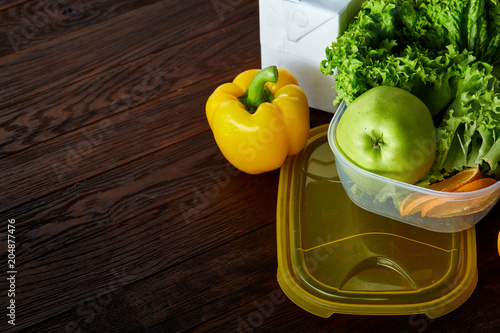 Healthy lunch prepared in small plastic container, top view, close-up. photo