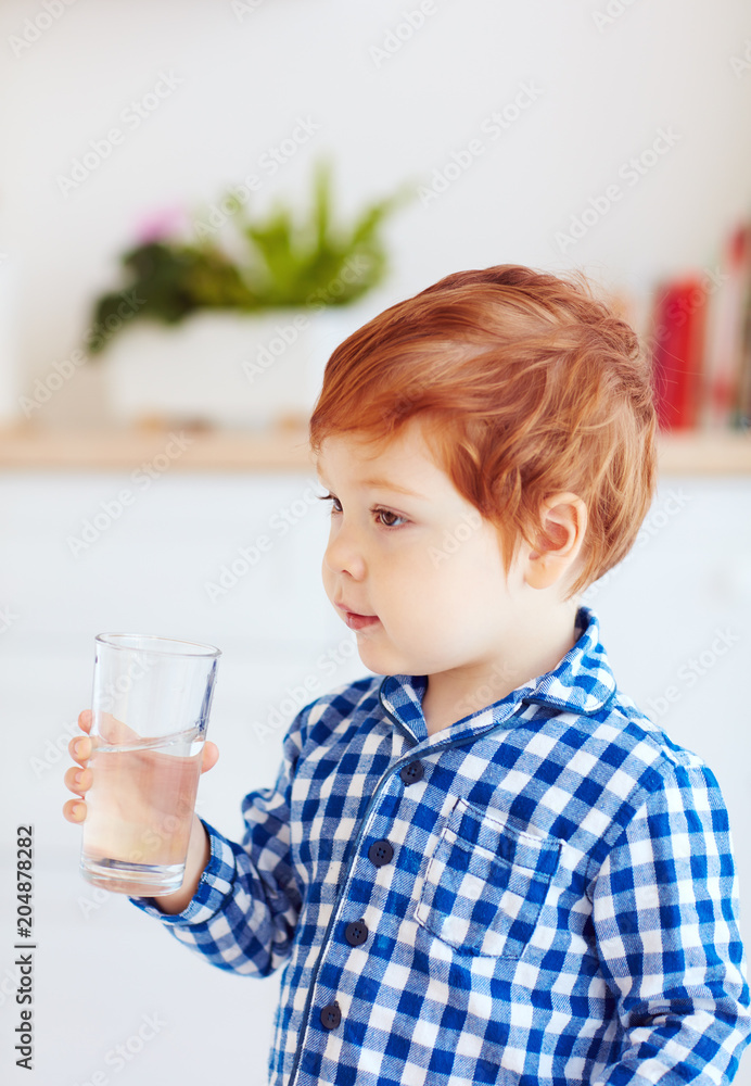 portrait of cute toddler baby boy holding a glass of fresh water in the morning portrait of cute toddler baby boy holding a glass of fresh water in the morning