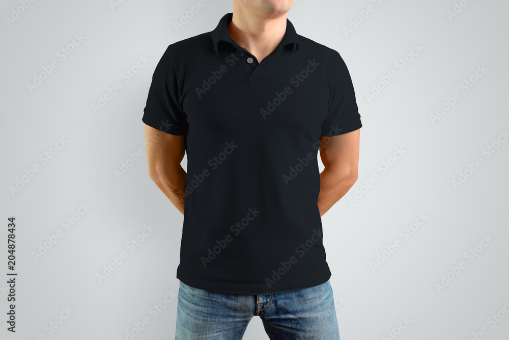 Mockup  black polo shirt on a strong guy. Isolated on a gray background. - obrazy, fototapety, plakaty 