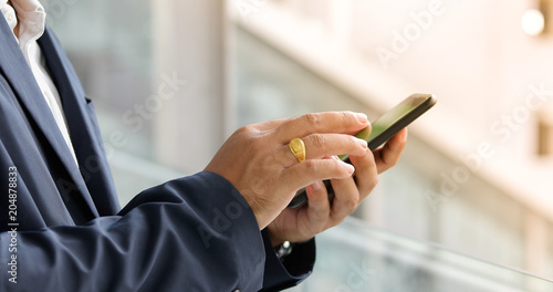 Businessman asian using phone for celling and texting on her mobile phone
