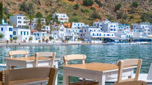 Restaurant tables with view on the scenic village of Loutro in Crete, Greece