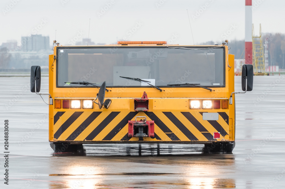 Aerodrome tow tractor is driving along the steering paths at the