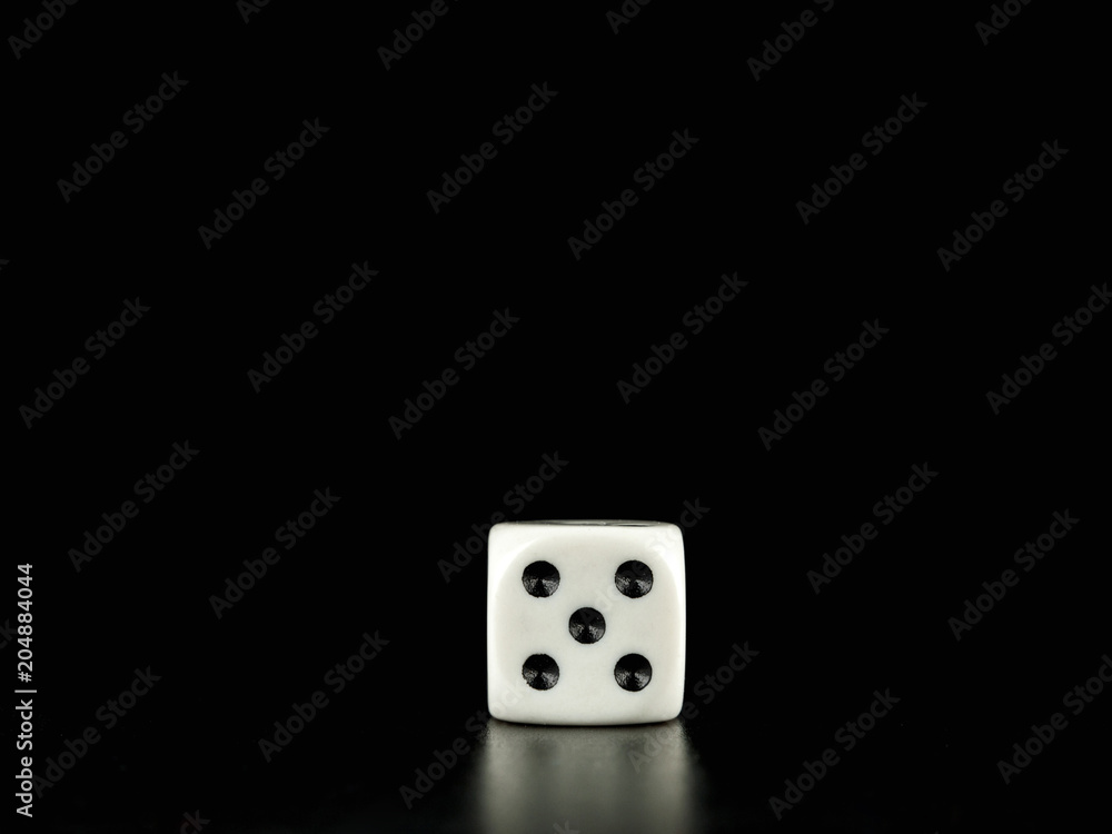 Game die isolated against black background, face with number five Game die isolated against black background, face with number five