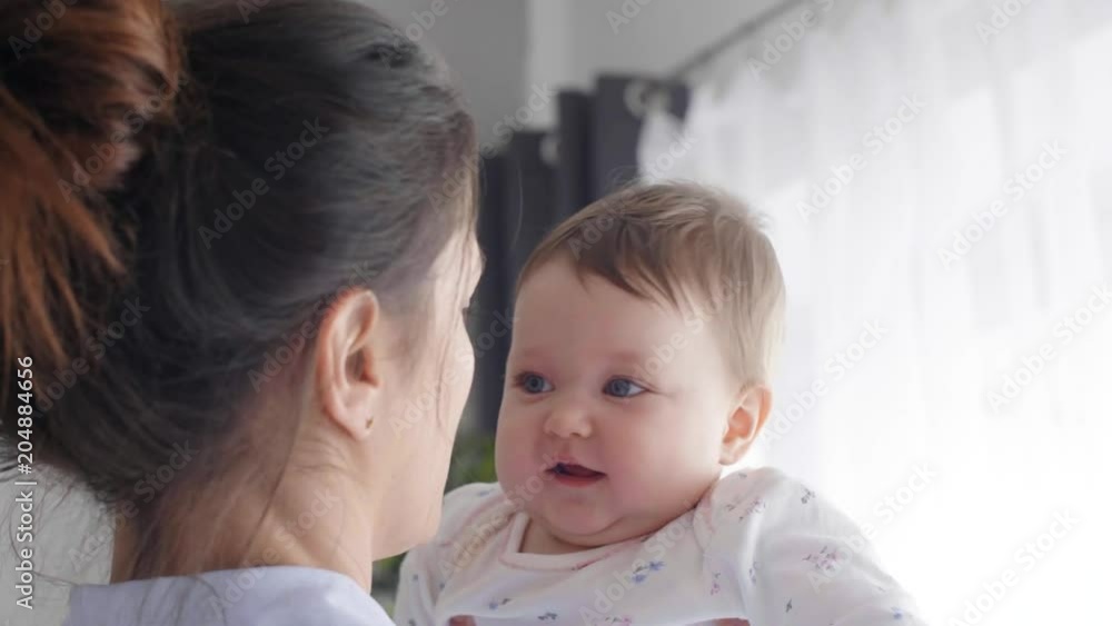Part of mother playing with baby girl at bedroom Part of mother playing with baby girl at bedroom