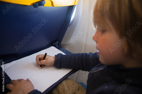 Child painted on the table of an airplane. photo