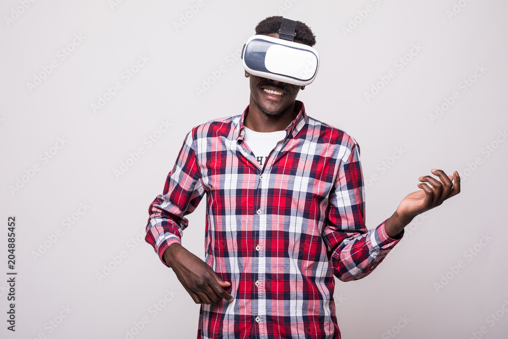 young happy and excited afro american man wearing virtual reality vr play guitar on white young happy and excited afro american man wearing virtual reality vr play guitar on white