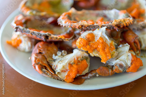 Boiled crab fresh and hot - delicious appetizer, steamed crab showing the delicious crab's eggs inside its shell
