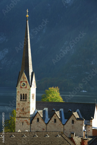 view of one of the Hallstatt's landmarks the church clock tower standing against mountain background