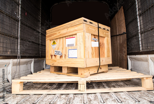 Radiation label beside the transport wooden box Type A package in the truck