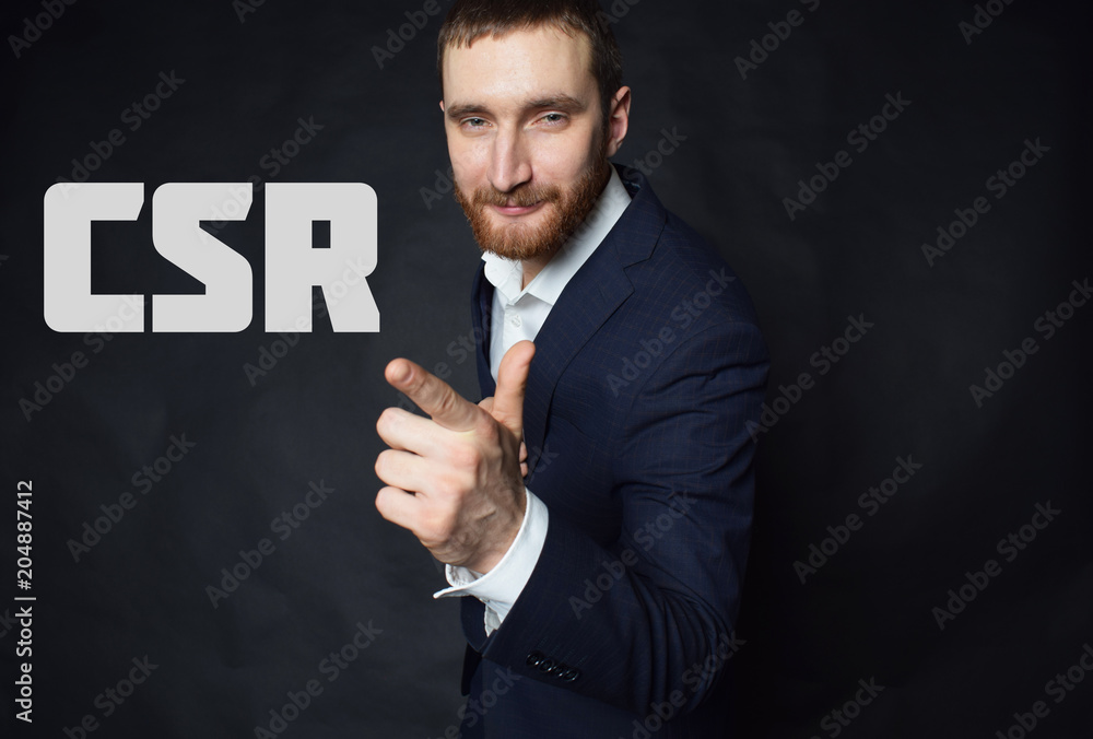 A businessman shows an inscription:CSR A businessman shows an inscription:CSR