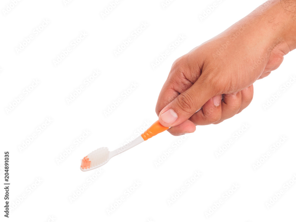 hand holding toothbrush hand holding toothbrush