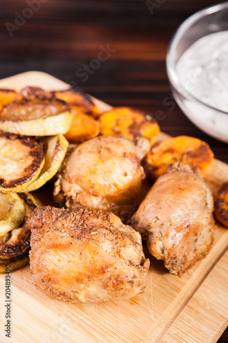 Healthy and delicious dinner made of fried chicken and grilled vegetables on wooden plate