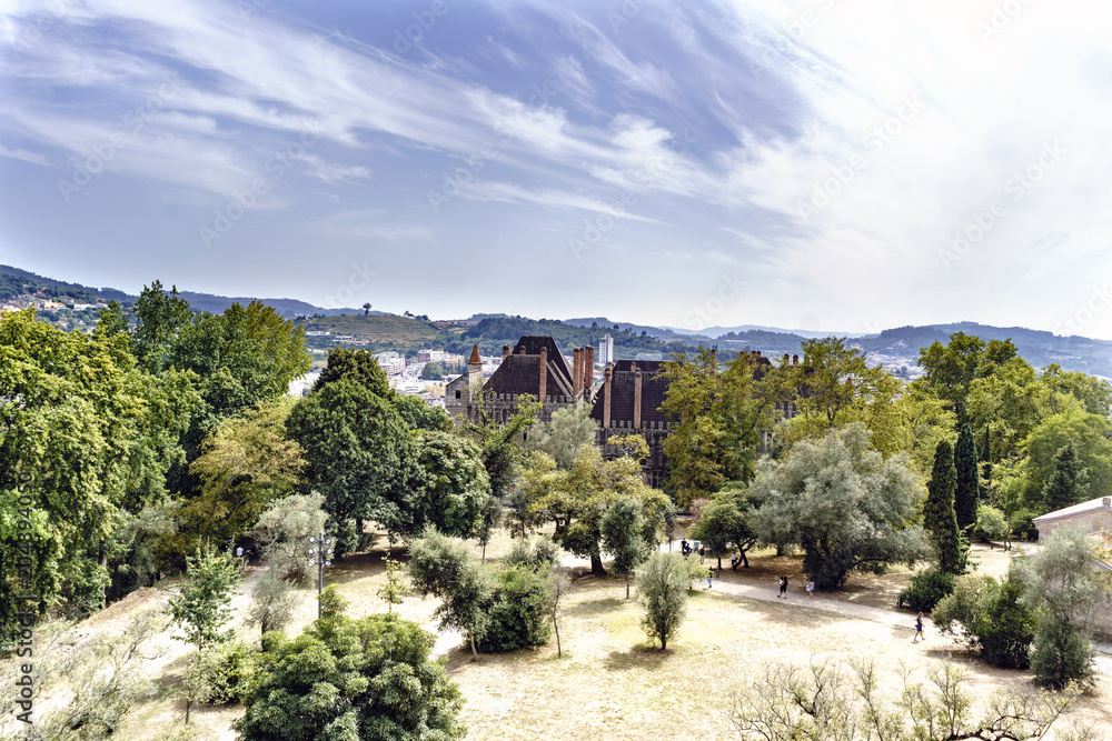 Panoramic from the battlements of the castle of King Afonso Henriques with the roofs and chimneys of the palace of the Dukes of Braganza and detail of its brick chimneys. O Panoramic from the battlements of the castle of King Afonso Henriques with the roofs and chimneys of the palace of the Dukes of Braganza and detail of its brick chimneys. O