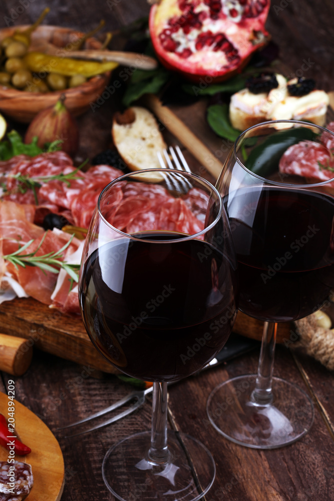 Italian antipasti wine snacks set. Cheese variety, Mediterranean olives, pickles, Prosciutto di Parma and salami Italian antipasti wine snacks set. Cheese variety, Mediterranean olives, pickles, Prosciutto di Parma and salami