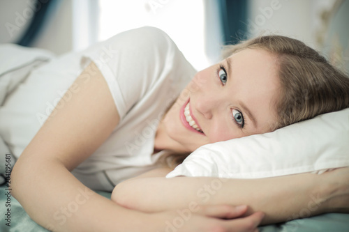 Portrait of fresh faced girl lying in bed