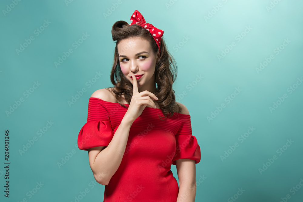 Beautiful young woman with pinup make-up and hairstyle. Studio shot on white background Beautiful young woman with pinup make-up and hairstyle. Studio shot on white background