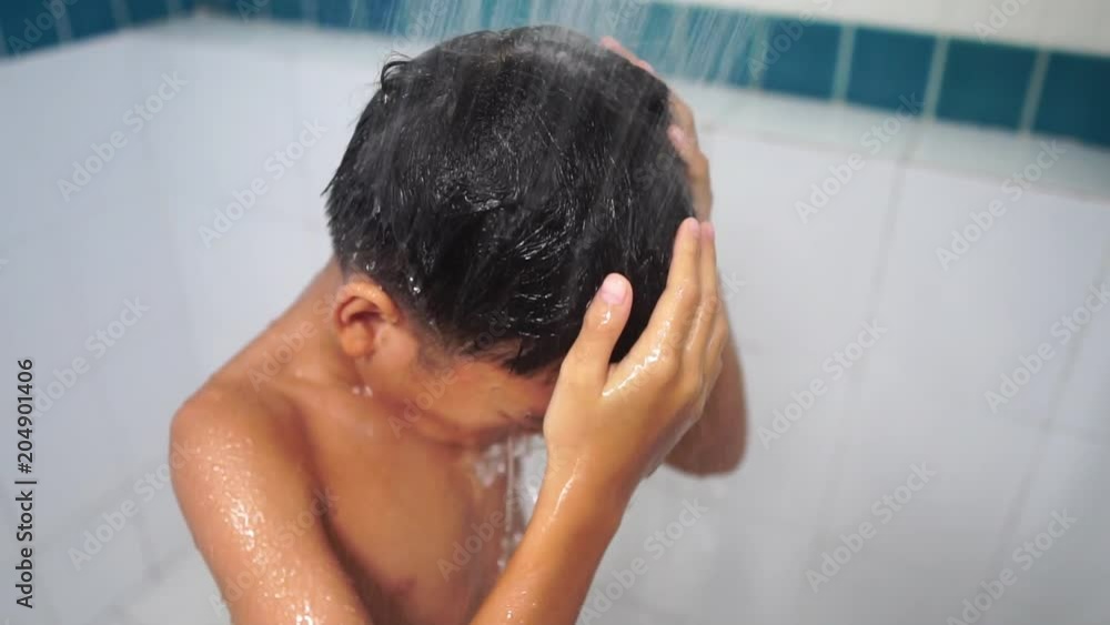 Slow motion of young Asian boy take a shower in bathroom Slow motion of young Asian boy take a shower in bathroom