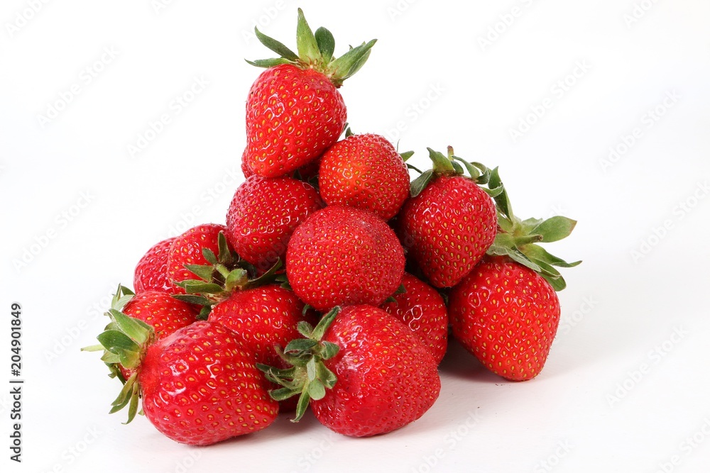 a heap of fresh strawberries are lyign in the studio a heap of fresh strawberries are lyign in the studio