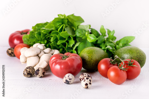 Healthy Diet Food on White Background Vegetables Tomatoes Peppers Green leaves Mushrooms Eggs Diet Food Concept Ingredients for Salad