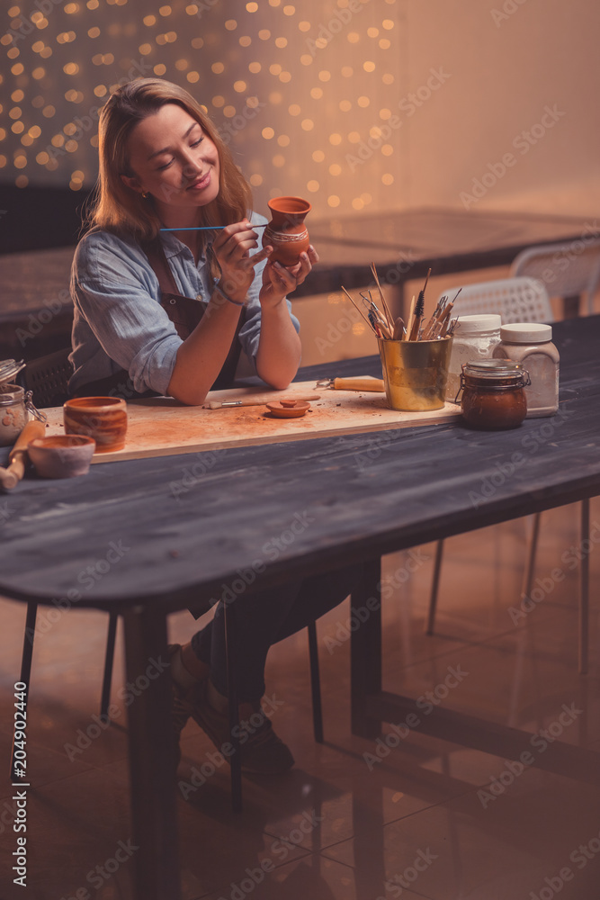 Smiling woman in a pottery studio Smiling woman in a pottery studio