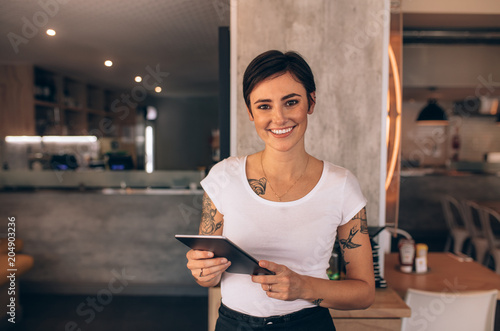 Female restaurant owner with a digital tablet