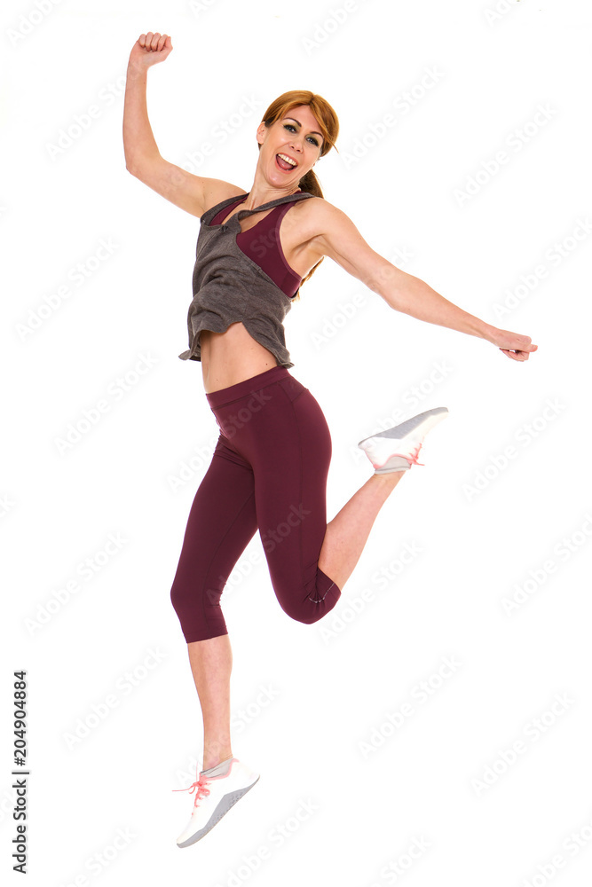 Attractive older woman in sportswear jumping Attractive older woman in sportswear jumping