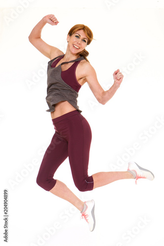 Fitness woman jumping in studio