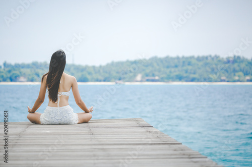 Woman meditation on bridge © Peera