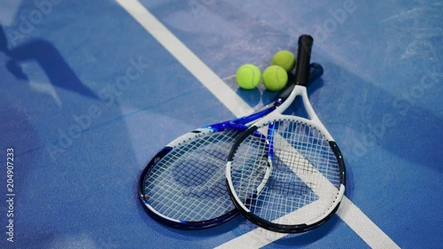 Tennis Ball and Racket on a Blue Court with room for copy. photo