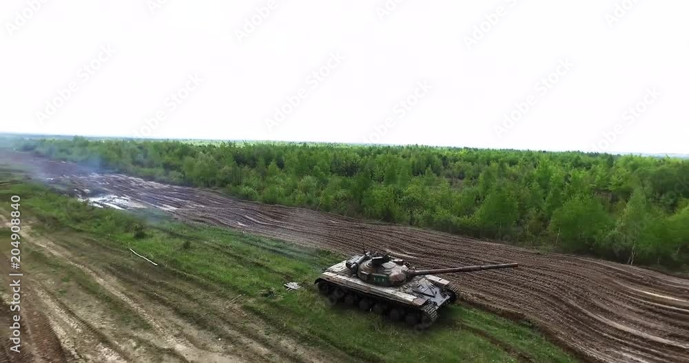Military Tank In Movement On A Dirt Ground Terrain Military Tank In Movement On A Dirt Ground Terrain