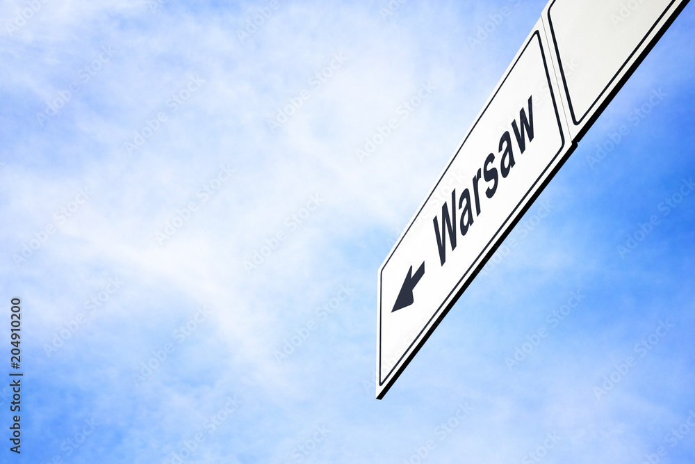 Signboard pointing towards Warsaw