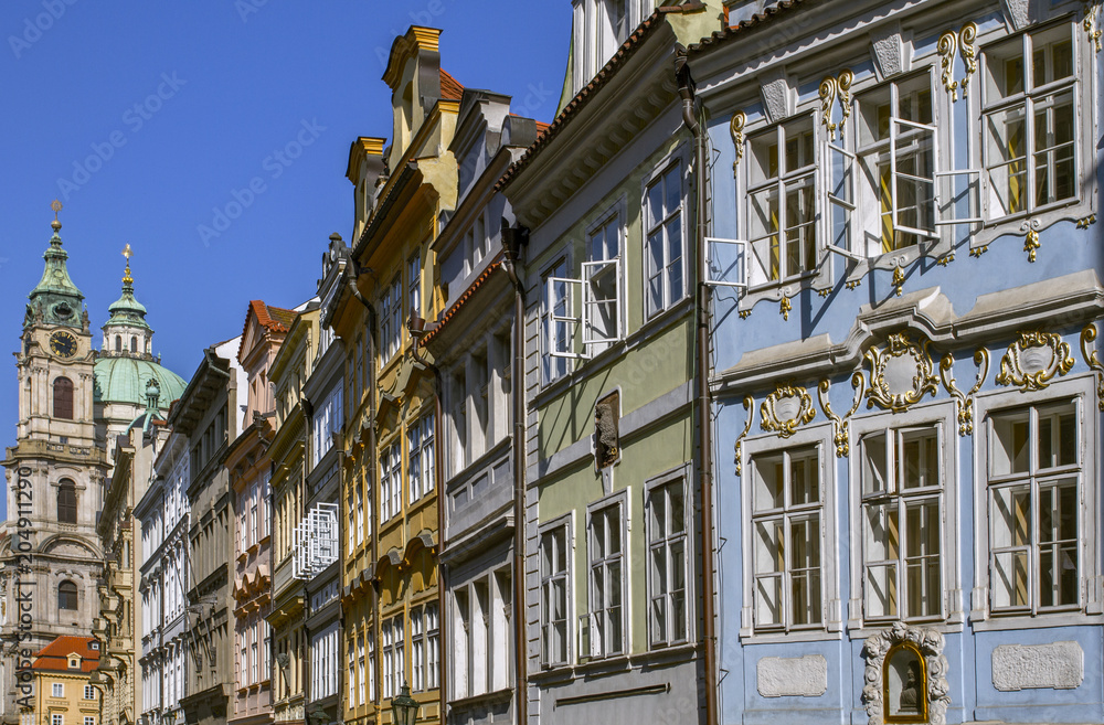 Fototapeta premium View on old city .Traditional medieval buildings .In the background could see the beautiful Cathedral of St. Nicholas. Sunny Morning. Prague, Czech Republic. European travel.